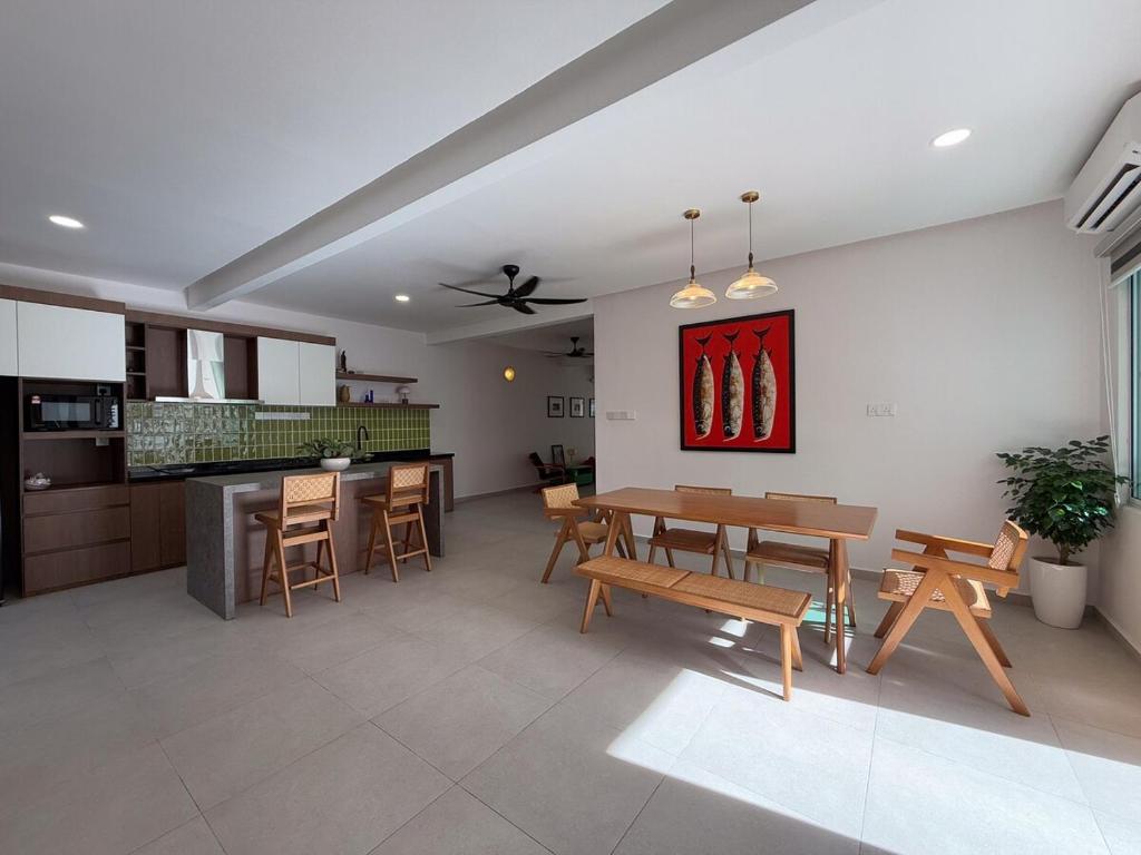a kitchen and dining room with a table and chairs at Beachside escape in Kuala Terengganu, Malaysia in Kampong Cherong Baru