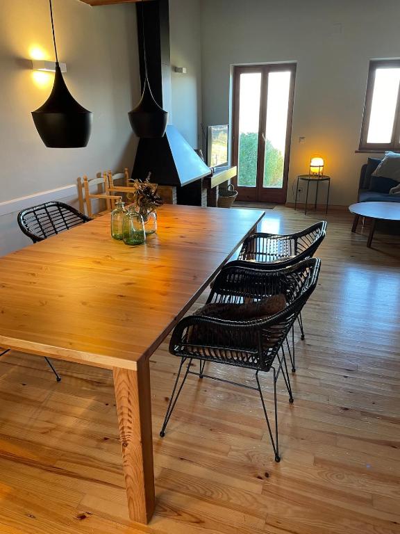 a large wooden dining table with chairs around it at Casa Muntanya EL Vilar Fontanals de Cerdanya in Urtx