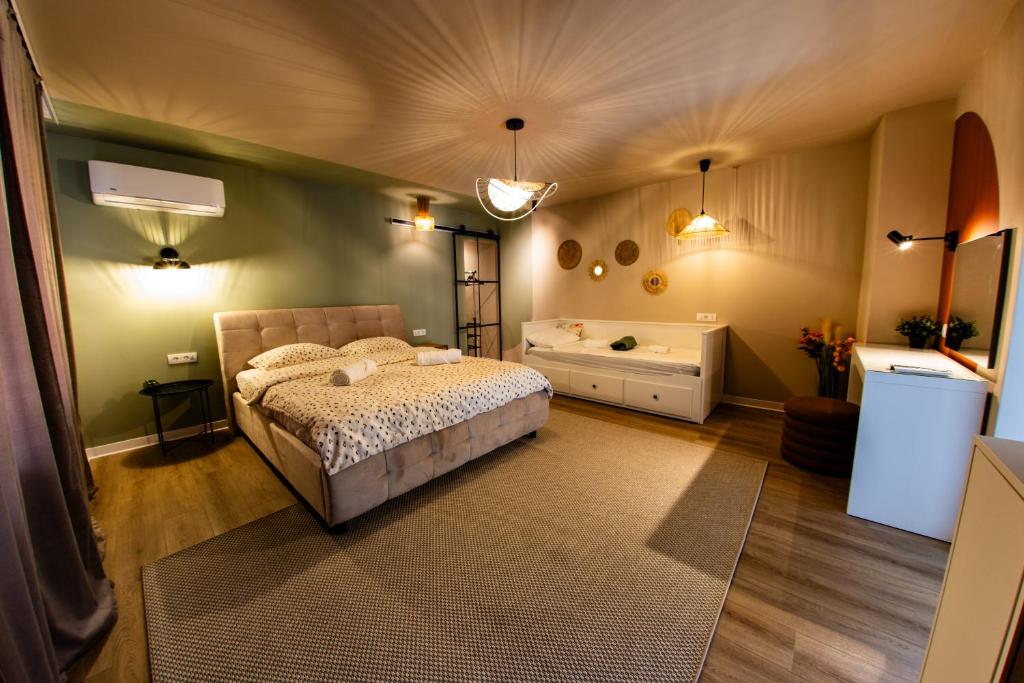 a bedroom with a bed and a tub in it at FLH - Citadel Garden Central Free Parking in Alba Iulia