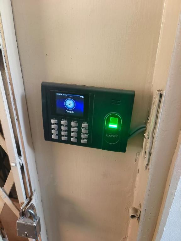 a door with a green button on the wall at Vyavasthapan hostels in Pune