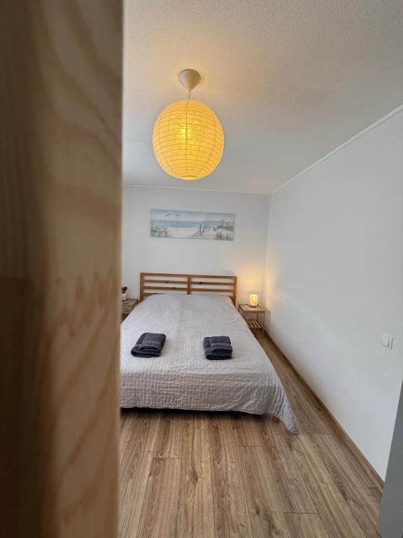 a bedroom with a bed with two towels on it at Klaipėda Old Town Stay in Klaipėda