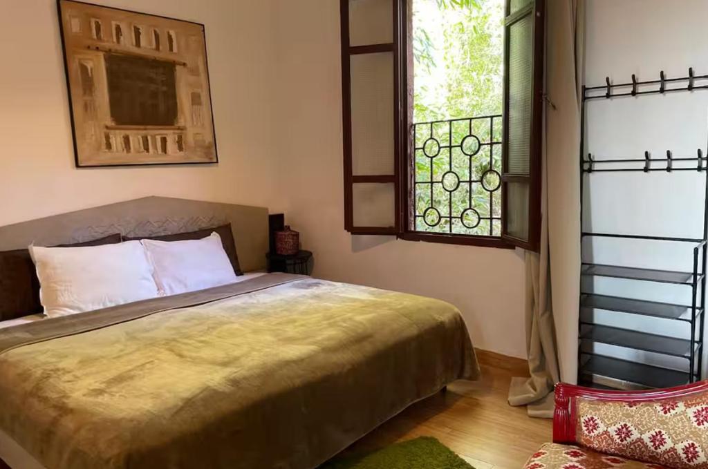 a bedroom with a bed and a window at FAKHARA Hostel in Marrakech
