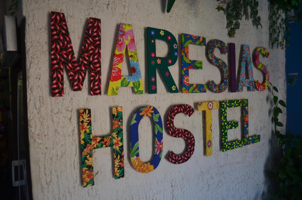 a sign that says newcastle high school on a wall at Maresias Hostel & Suites in Maresias