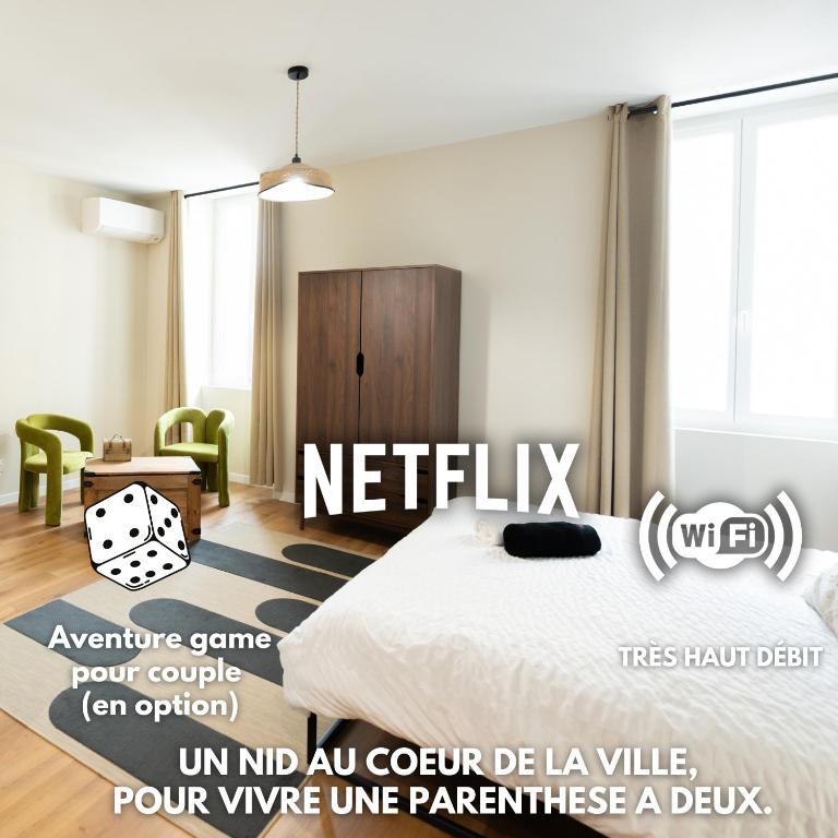 a bedroom with a bed and a table and chairs at La Loulove - Nid cosy & design au cœur de Lauzerte in Lauzerte