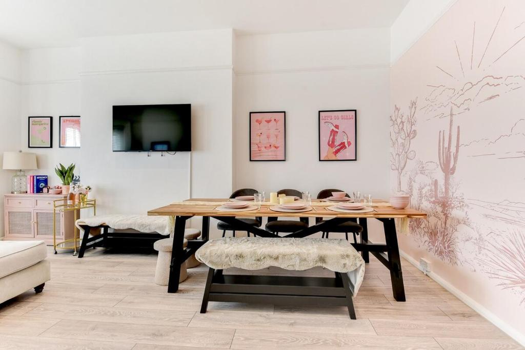 a dining room with a table and a couch at Seafront apartment in Bognor Regis