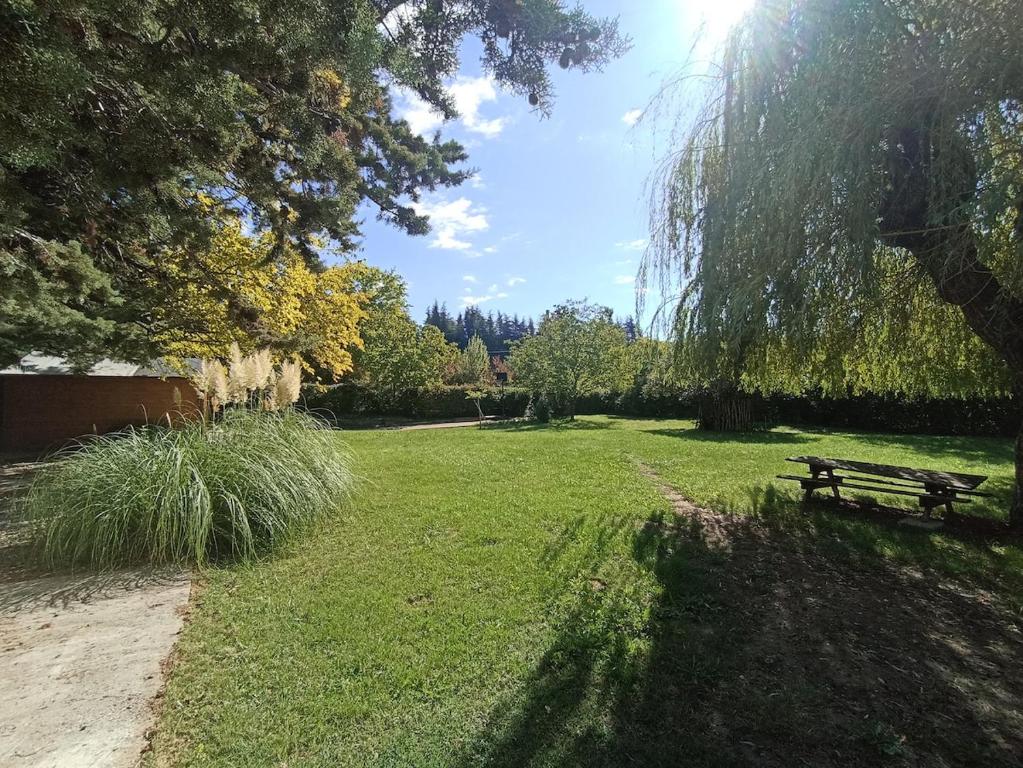 a park with a bench in the grass at Villa Bel Air in Saint-Étienne-les-Orgues