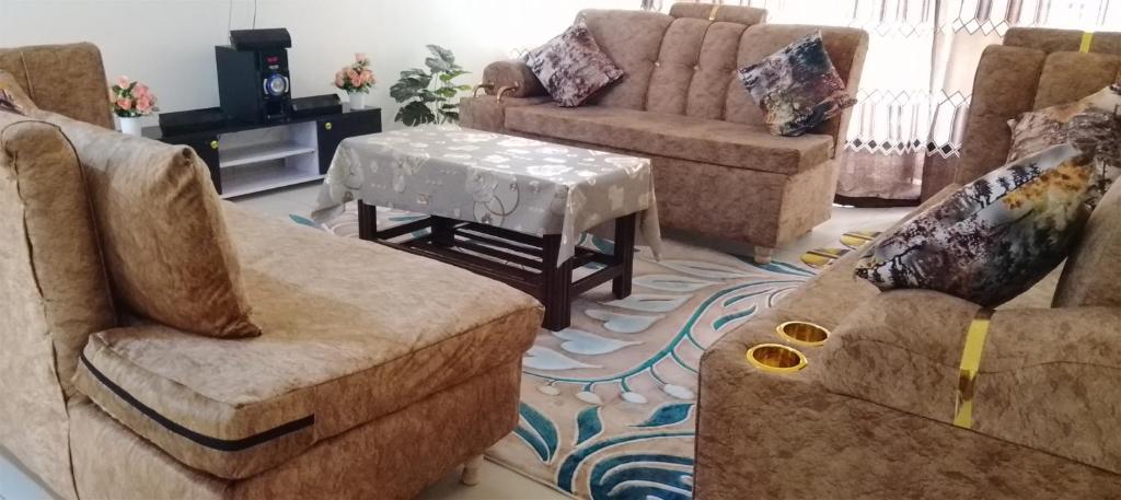 a living room with a couch and a table at SEBULENI SEA LUXURY HOMESTAY WALK TO NYALI BEACH Mombasa in Mombasa