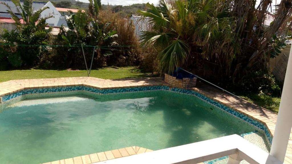 a large swimming pool in a yard with trees at 35 Pearce in Vosburg