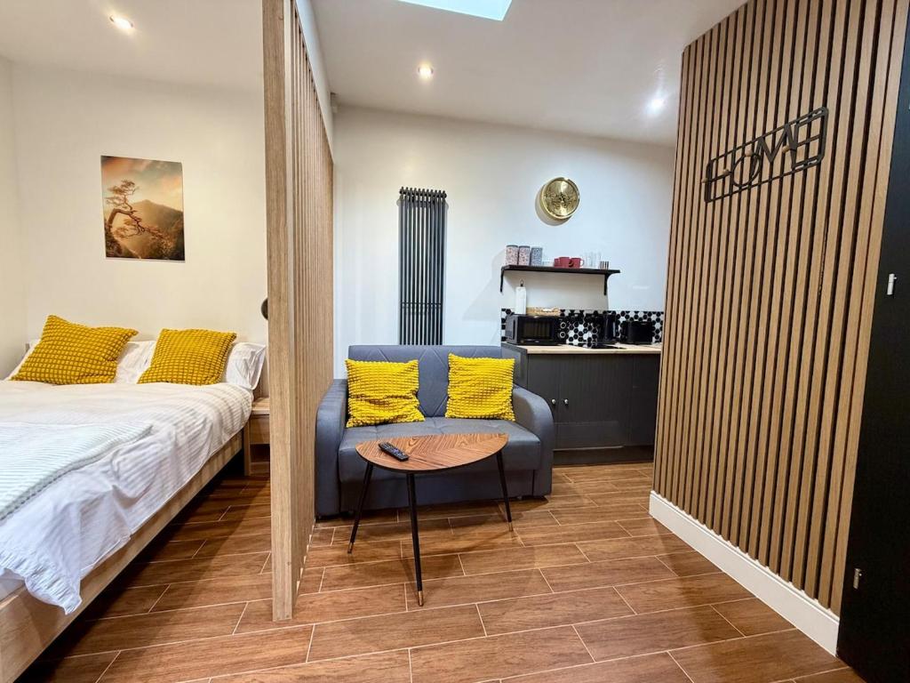 a bedroom with a bed and a chair and a table at The Cabin at the Orchard House- Stricly No Parties in Barton in the Clay