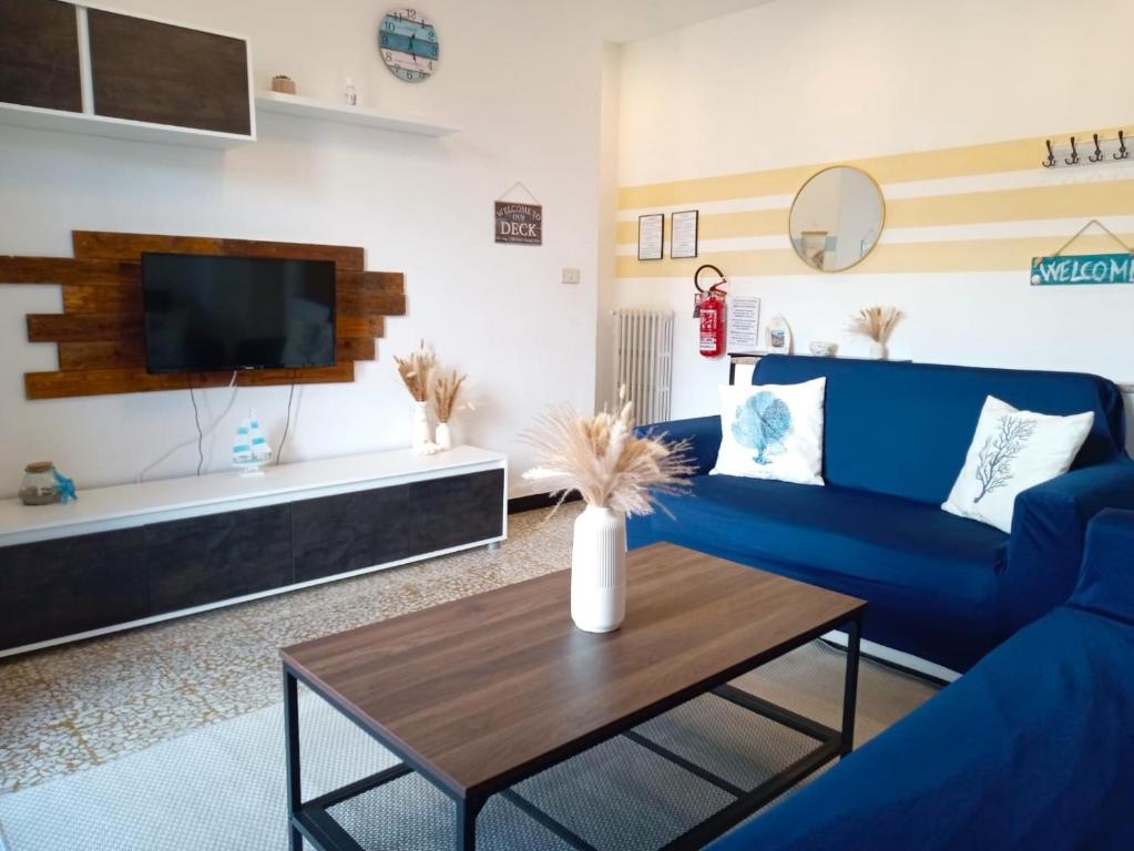 a living room with a blue couch and a table at L'Attico sul Porto, Sea View with Terrace, Imperia Center in Imperia