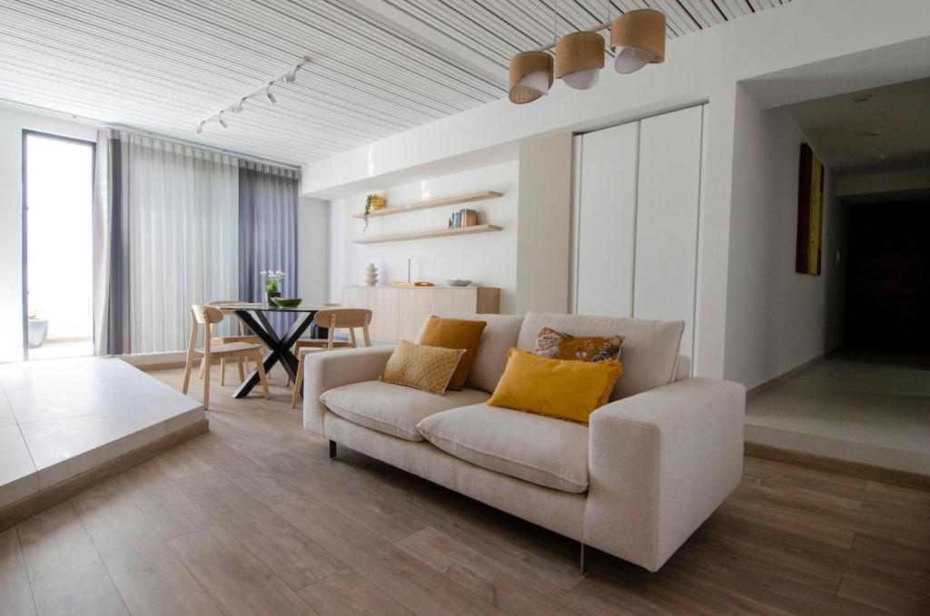 a living room with a couch and a table at Chic 2BR Apartment Steps from the Gzira Seafront in Il-Gżira