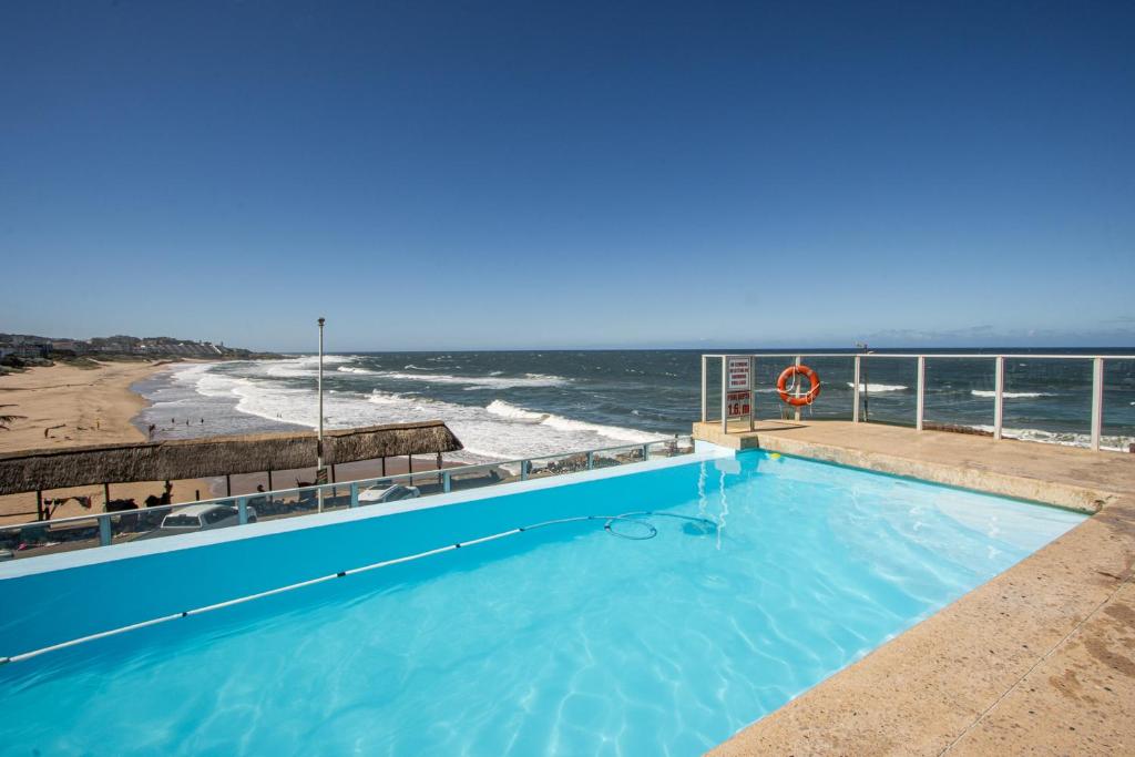 a swimming pool with a view of the ocean at Seagull 407 in Margate
