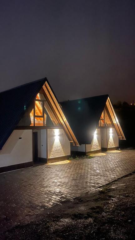 two buildings with lights on them at night at Willa's Trebisonda Bungalov in Arsin