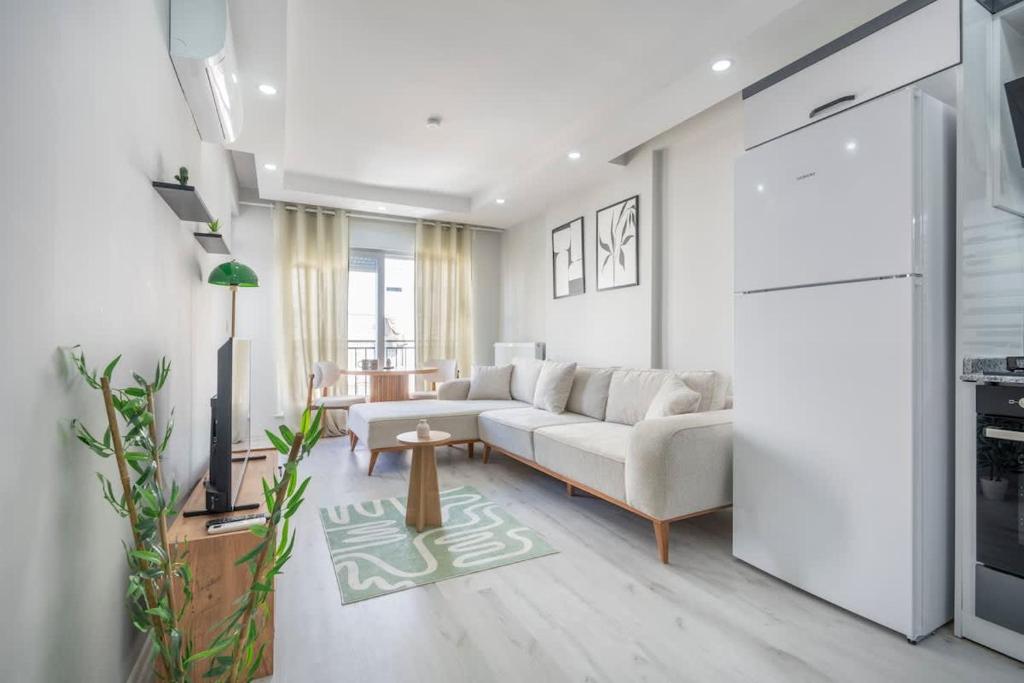 a living room with a couch and a table at Boho Style Flat with Free WiFi Near Kaleici & AVM in Antalya