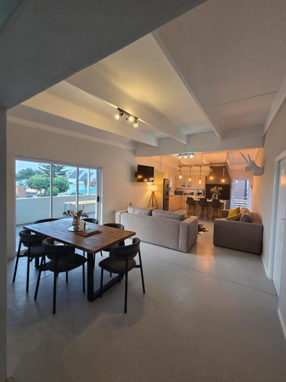 a large living room with a table and a couch at Stoepstories in Yzerfontein