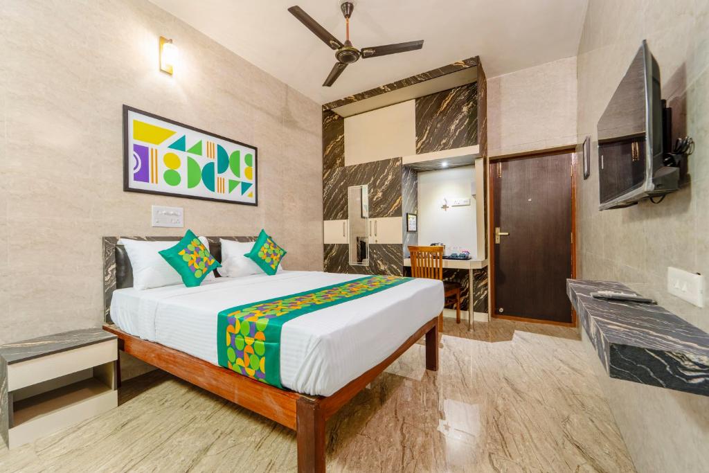 a hotel room with a bed and a tv at Treebo Dunag in Coimbatore