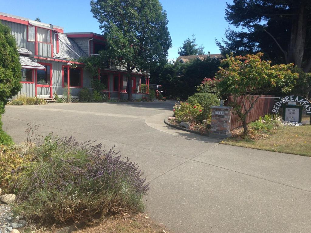 an empty street in front of a red building at Estuary House Reflexology B&B in Courtenay