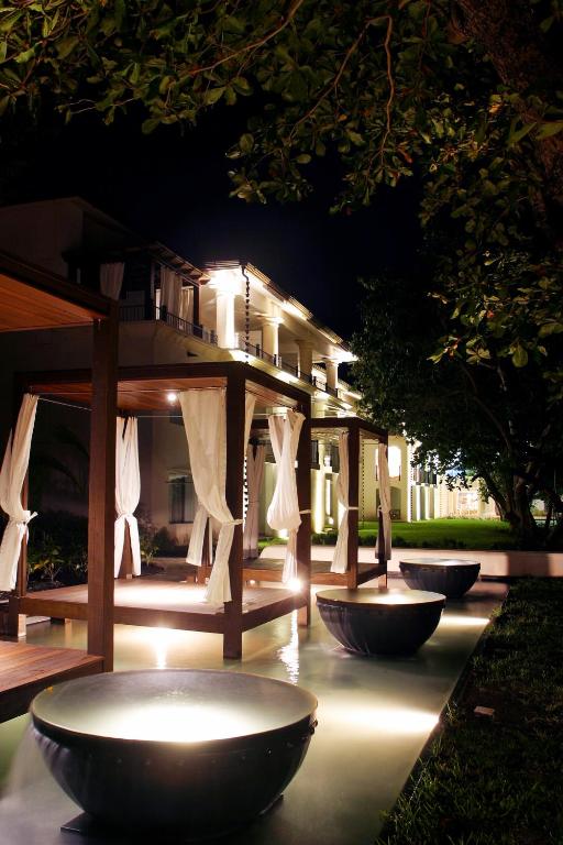 a group of bowls in front of a house at night at Casa Colonial Beach & Spa in San Felipe de Puerto Plata