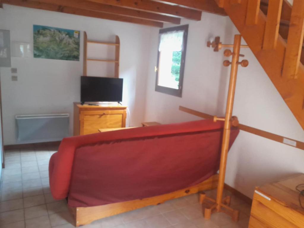 a living room with a red couch and a tv at Cauterets in Cauterets