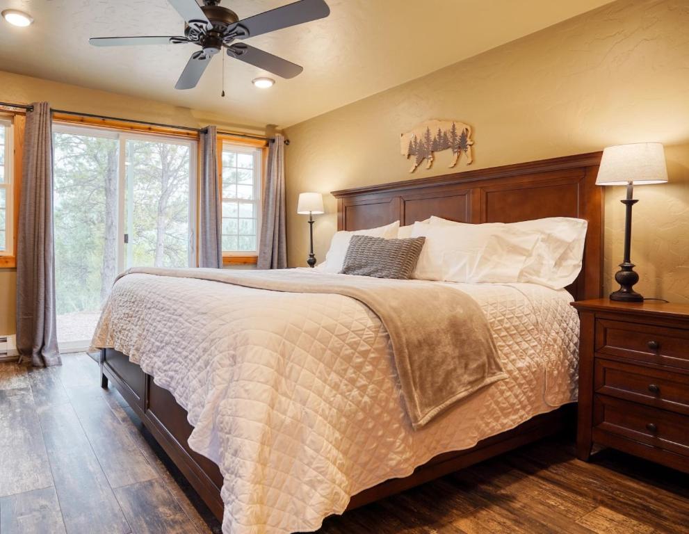 a bedroom with a bed and a ceiling fan at Ponderosa Cabin at Highland Meadows in Hot Springs