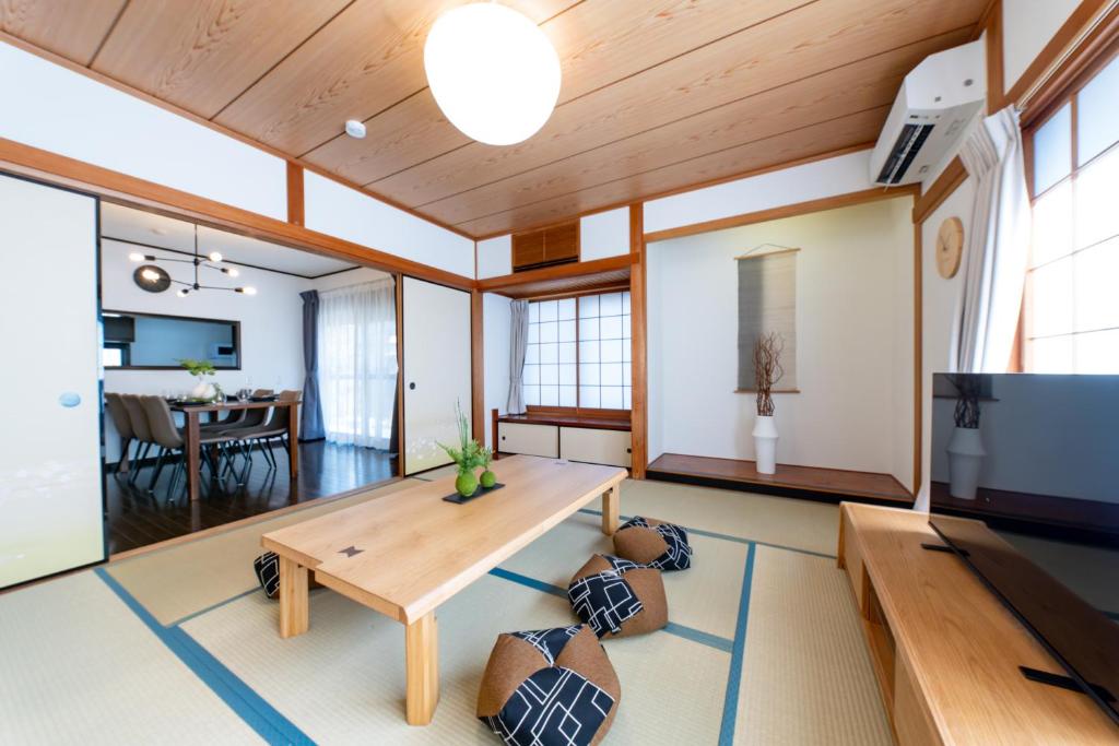 a living room with a table and a dining room at Haleluana SHIBAMATA in Tokyo