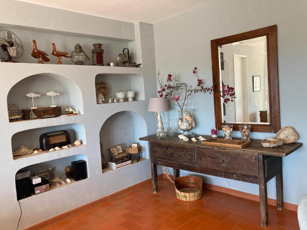a room with a table and a mirror and shelves at Country House With Private Pool in Poço do Álamo