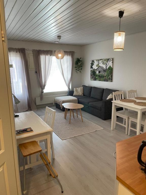 a living room with a couch and a table at Tilava kaksio saunalla in Seinäjoki