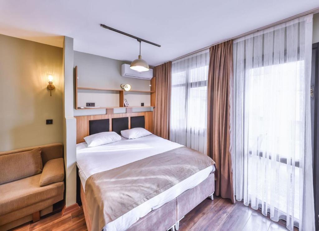 a bedroom with a large bed and a window at Peaceful Apartment Near Galata in Istanbul