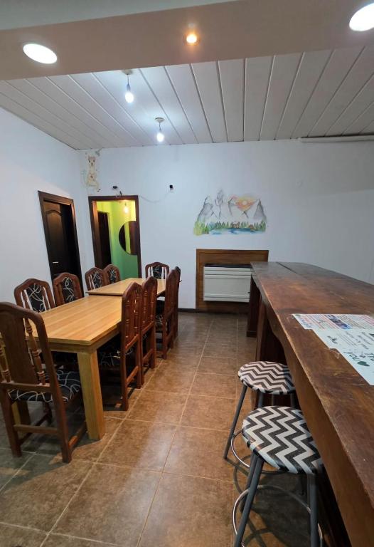 a dining room with wooden tables and chairs at Hostel Mapu Paigue in El Chalten