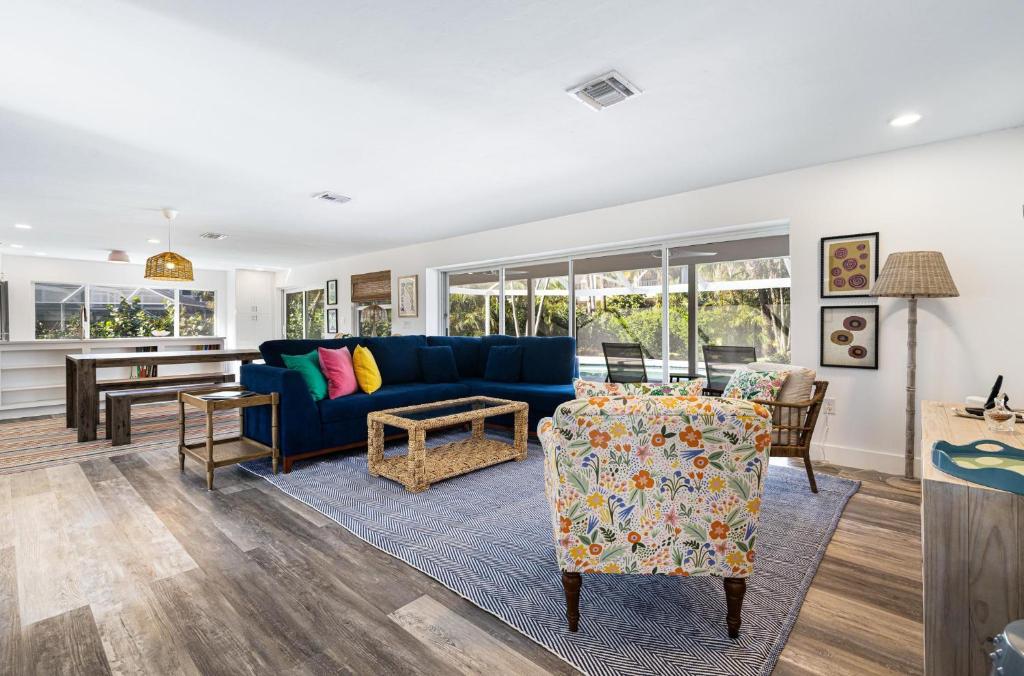 a living room with a blue couch and a table at The Allen Home in Sanibel