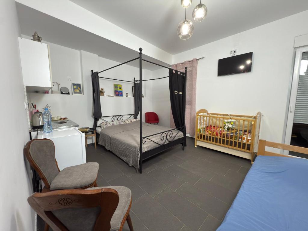 a bedroom with a bed and a crib at Valencia in Vršac