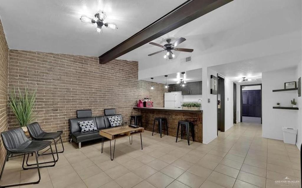 a living room with a couch and chairs and a kitchen at Charming 1BR Condo Near UTRGV & Downtown Edinburg in Edinburg