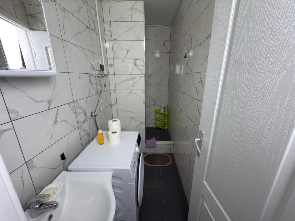 a white bathroom with a sink and a toilet at Valencia in Vršac