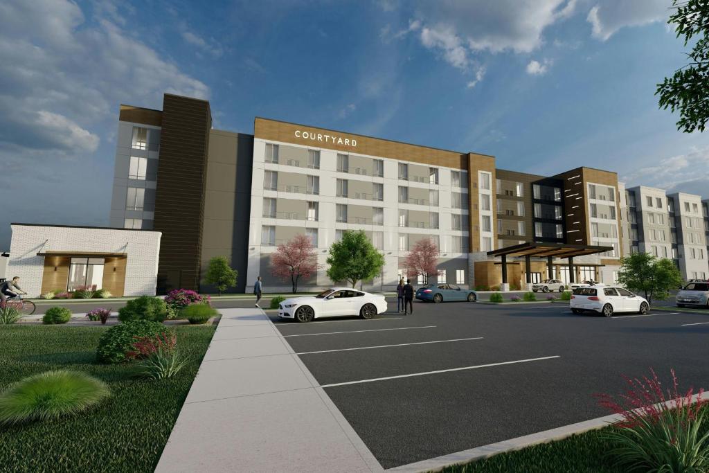 a rendering of a building with cars parked in a parking lot at Residence Inn by Marriott Madison in Madison