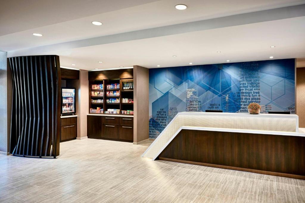 a lobby with a reception desk and a pharmacy at SpringHill Suites by Marriott Chesterfield in Chesterfield