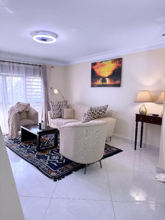 a living room with a couch and a table at Munyonyo Haven in Kampala