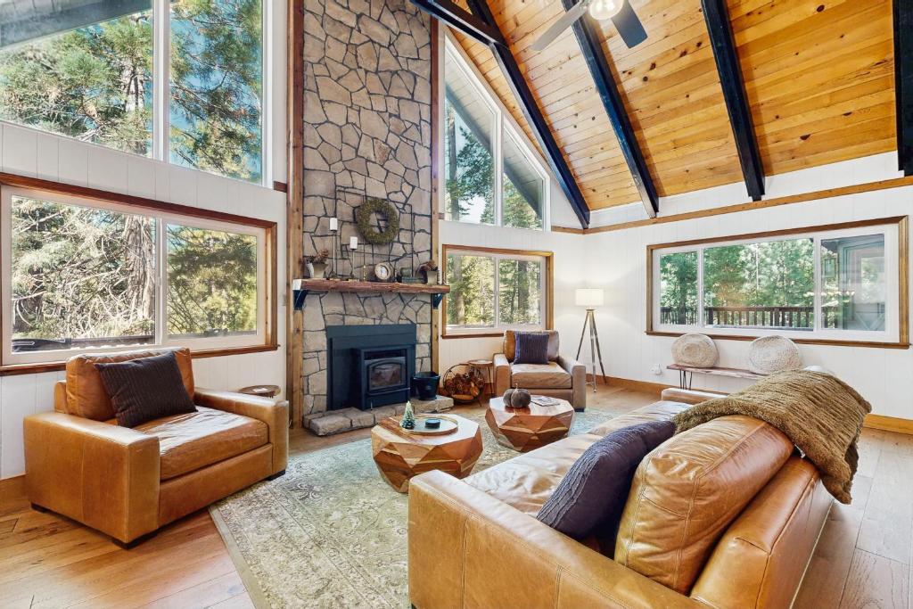 a living room with a couch and a fireplace at Hot Tub, Game Room & Home Gym: Serene Arnold Gem in Arnold