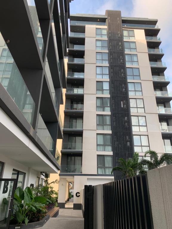 a tall building with a fence in front of it at Real Escal 1 bedroom at Airport Residential in Accra