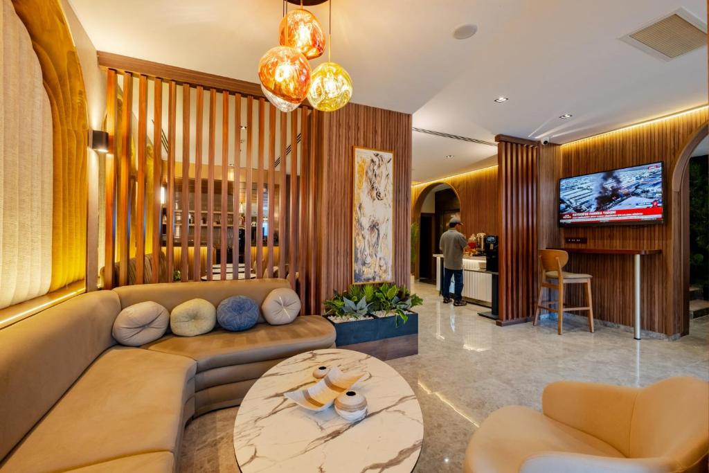 a living room with a couch and a table at Garner Hotel Istanbul - Airport Arnavutkoy by IHG in Istanbul