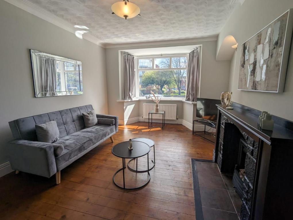 a living room with a couch and a fireplace at Lovely 2 Bedroom Getaway in Newcastle upon Tyne