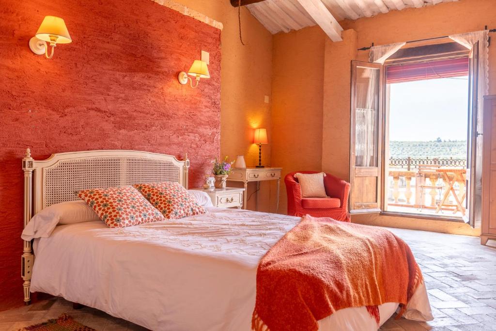 a bedroom with a bed and a large window at La Festa Dels Sentits, Casa Rural in Sant Martí de Maldá