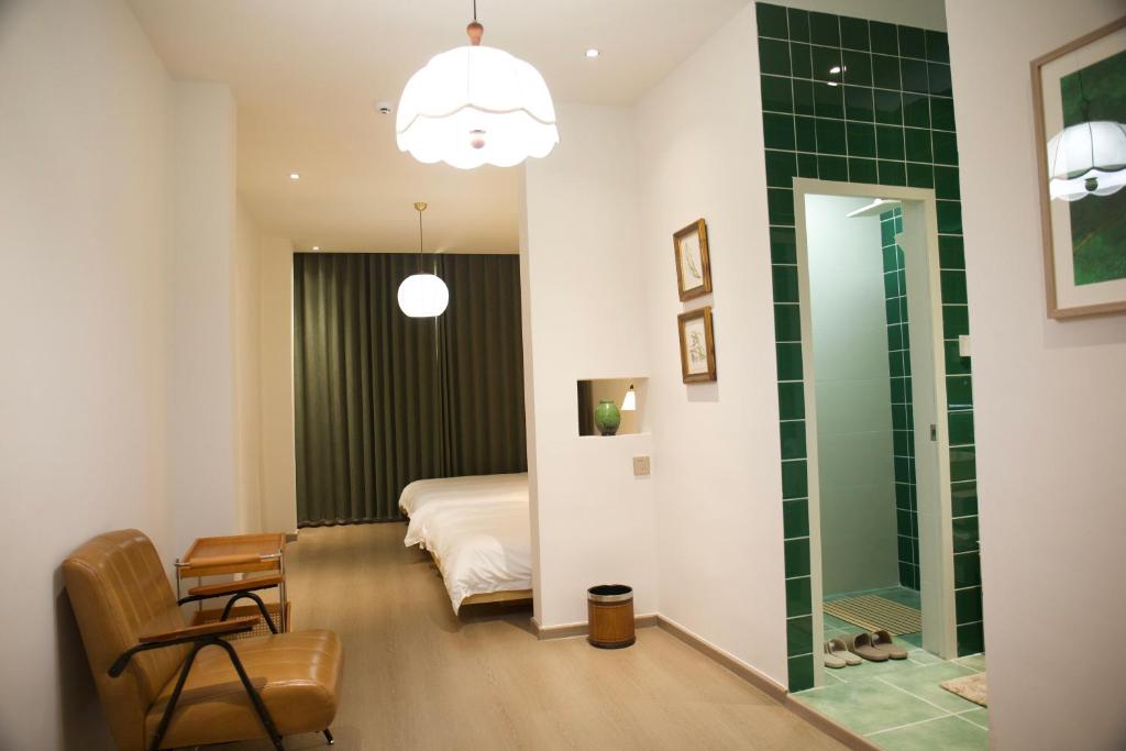 a bedroom with a bed and a glass shower at Yunxi Courtyard in Zhangzhou