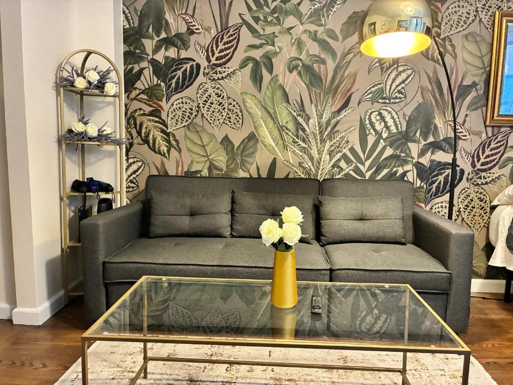 a living room with a couch and a table at West Village Lush Green in New York