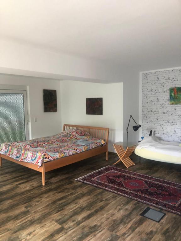 a bedroom with two beds and a rug at VeWö Seeklang in Velden am Wörthersee