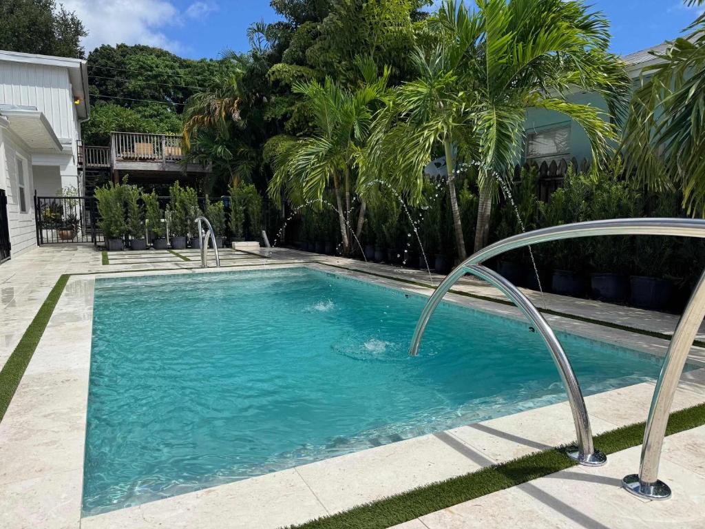 a swimming pool with a metal rail around it at Newly Renovated 1BR apartment in the heart of WPB in West Palm Beach