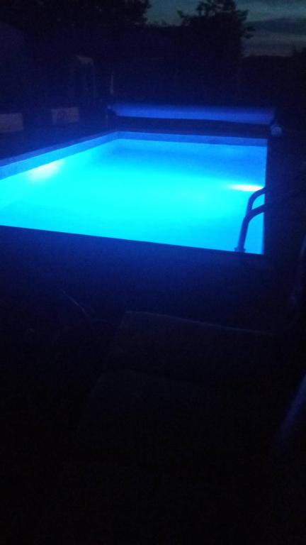 a swimming pool with blue light in the dark at Lauterhofen Haus 8 in Lauterhofen