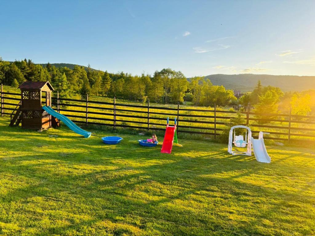 a playground with a slide at Casa Hardic in Horodnic de Sus