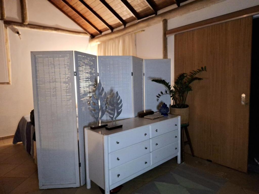 a bedroom with a dresser and a chest of drawers at Loft charmoso! in Água Boa
