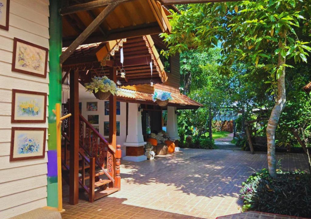 a building with a staircase and a stair case at Him Jan Home in Ban Kio Phrao