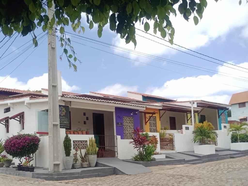 Una casa con plantas delante de ella. en Chalés Recanto das Flores RN, en Monte das Gameleiras